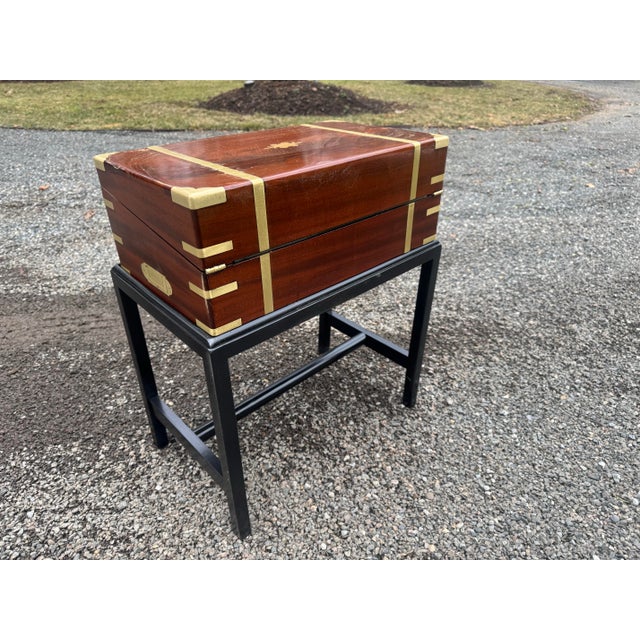 Handsome English campaign 19th century travel lap desk. Constructed of mahogany with brass mounts, the desk sits on a...