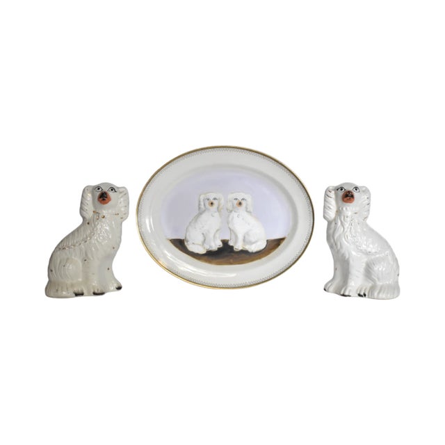 An antique pair of Victorian English Staffordshire spaniel dogs, white with gold gilt details, 5"x3.25"x7.25". Their...