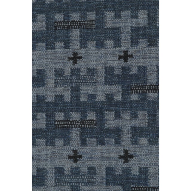 This 8x10 Scandinavian rug explores timeless Nordic geometry through a refined layout of layered motifs in blue, charcoal,...