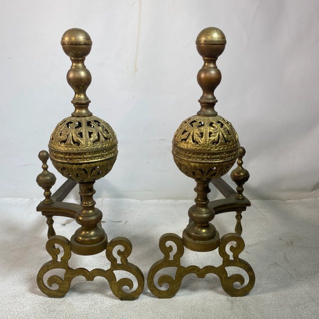 Quality antique pair of andirons which are in amazing shape with great pierced detail on ball tops and decorative solid...
