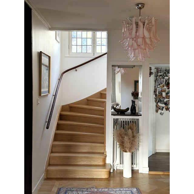 Set of two 2 pink contemporary murano chandeliers. Petal formed glass prisms in traditional italian mid-century style. The...