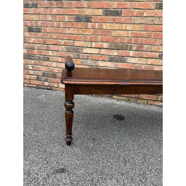 This is a vintage wood hall bench in English dark toned walnut with delicately hand carved rolled arms. Its solid...