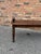This is a vintage wood hall bench in English dark toned walnut with delicately hand carved rolled arms. Its solid...