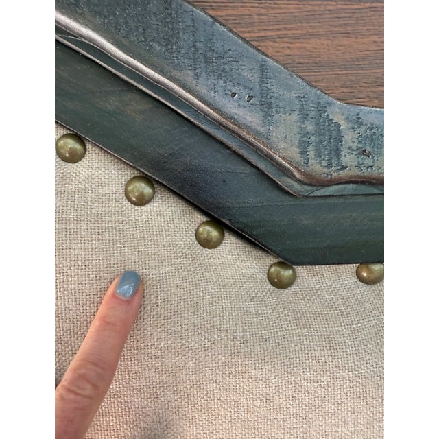 King headboard with a scalloped frame in a dark brown weathered finish and a natural pine back. Upholstered in wheat linen...