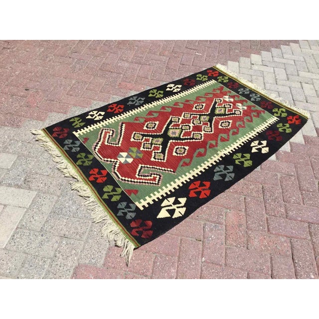 This beautiful, vintage, handwoven kilim is approximately 60 years old. It is handmade of very fine quality, hand-spun...