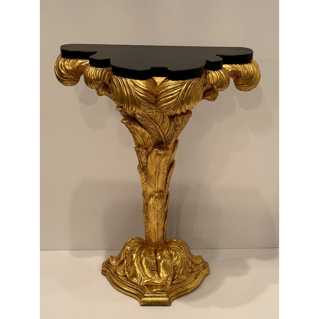 Stunning glamorous pair of diminutive giltwood console tables having palm leaf decoration and gorgeous contrasting...