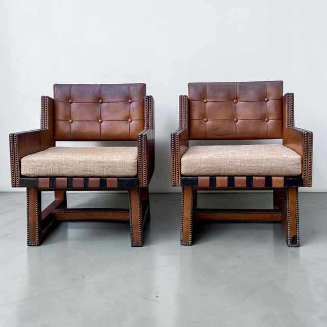 A strikingly stylish pair of French leather armchairs, dating to the 1930s or 1940s, combining superb craftsmanship with...