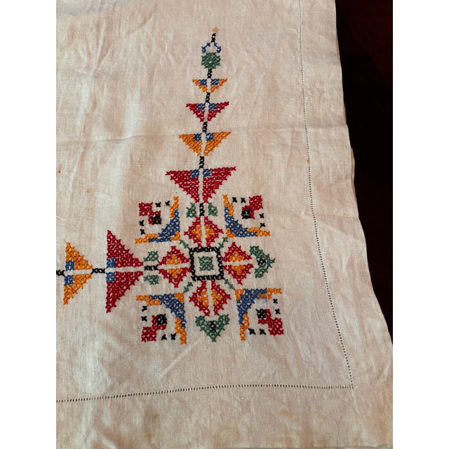 This charming vintage tablecloth features a geometric folk inspired cross stitch design. It is a heirloom stitched...