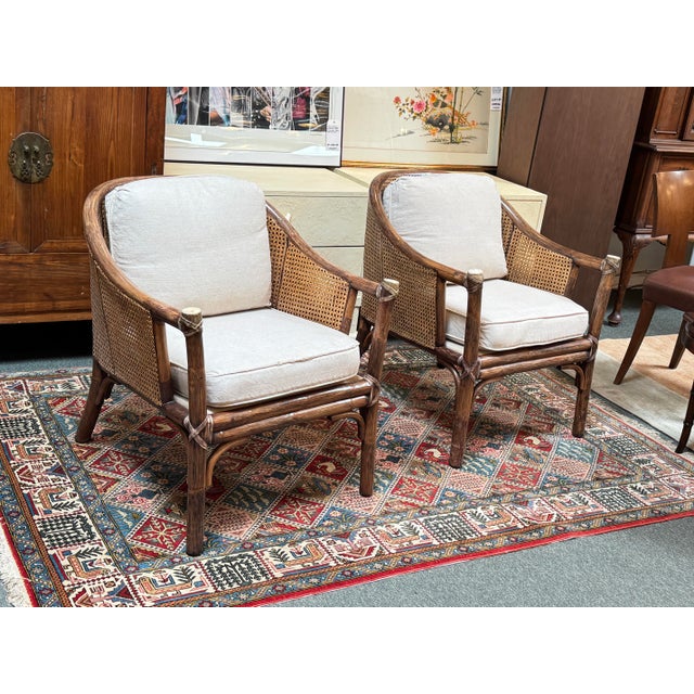 Design Plus Gallery presents a Pair of Vintage Barrel Rattan & Cane Lounge Armchairs by McGuire Furniture. These vintage...