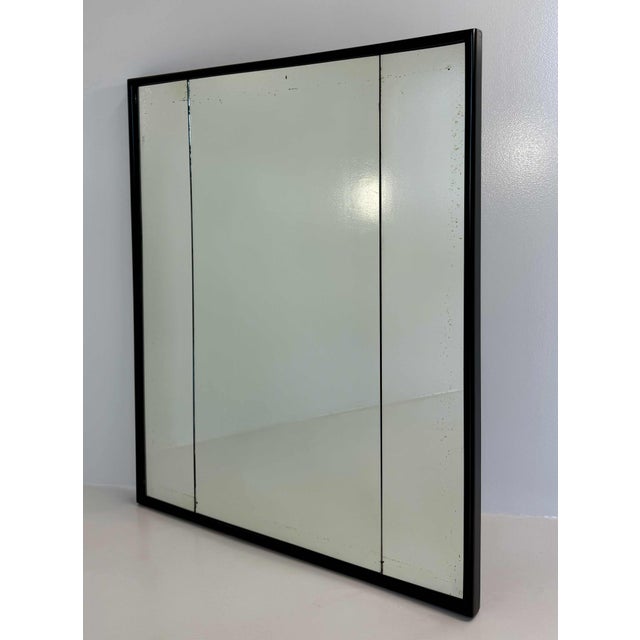Elegant Italian Art Deco mirror from the 1940s, attributed to Osvaldo Borsani, featuring a refined black lacquered frame...