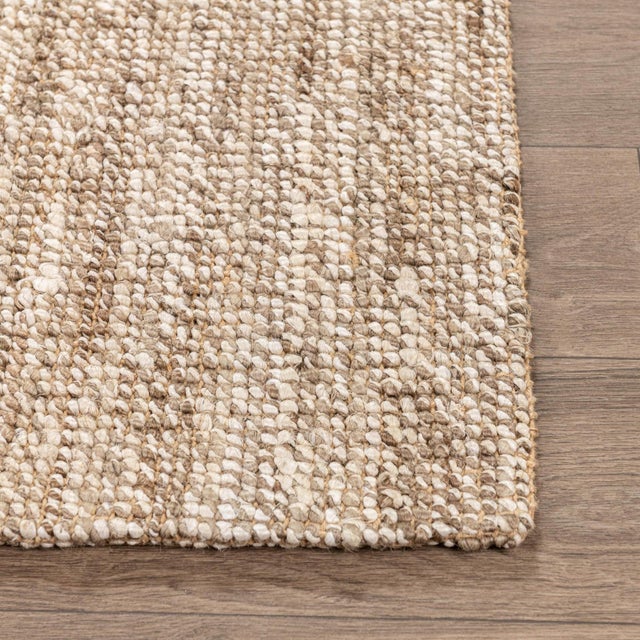 Hand woven boucle inspired soft jute rug in natural and ivory tones. Available in numerous sizes. Please note that its...