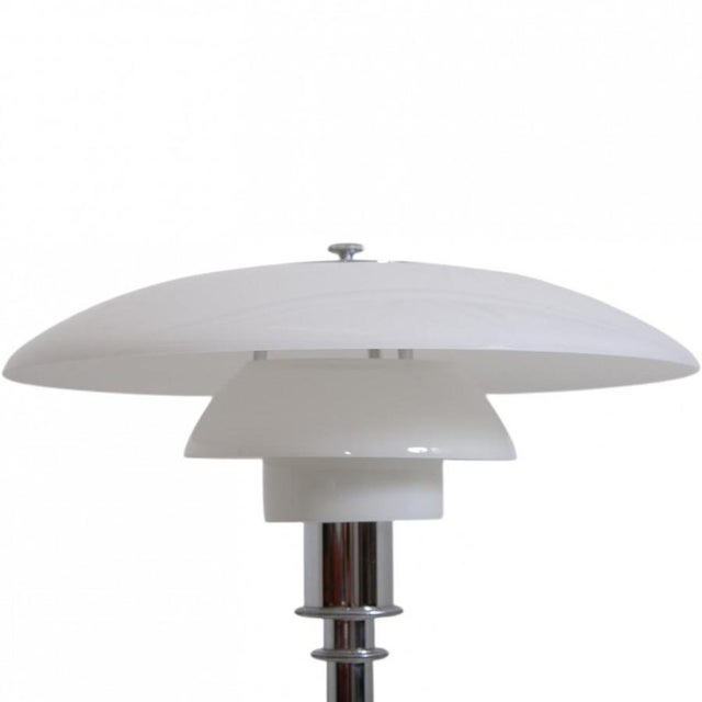 Poul henningsen ph 3/2 table lamp with shades of white opal glass and a chrome frame. The lamp is from the 2010s and...