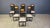 Set of 6 black lacquered wooden dining chairs with inserted burl wood panels and grey simili leather seats. They can also...