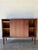 This Danish credenza sideboard features smooth sliding doors opening to reveal adjustable interior shelving and a felt-...