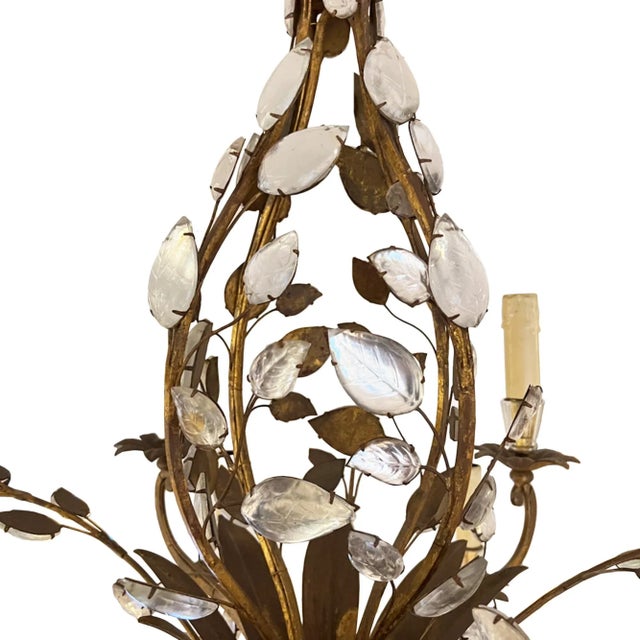A wonderfully elegant mid 20th century gilt metal and crystal chandelier by Maison Baguès. Made in Paris in the 1960s....