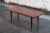 Swedish MCM Mahogany coffee table with turned legs and brass caps on the feet. The tabletop is in excellent condition and...