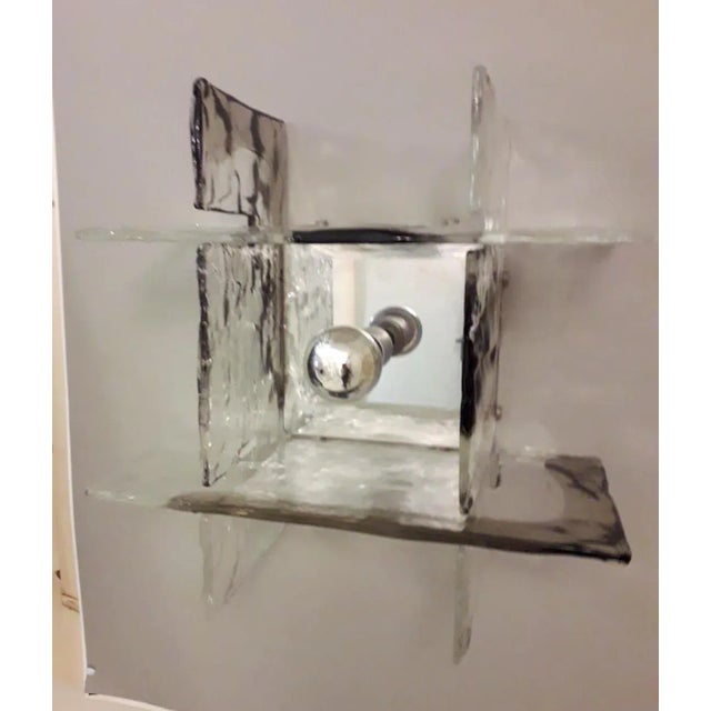 Vintage Italian wall lights with interlocking clear and smoky Murano puzzle-like glass pieces mounted on chrome metal...