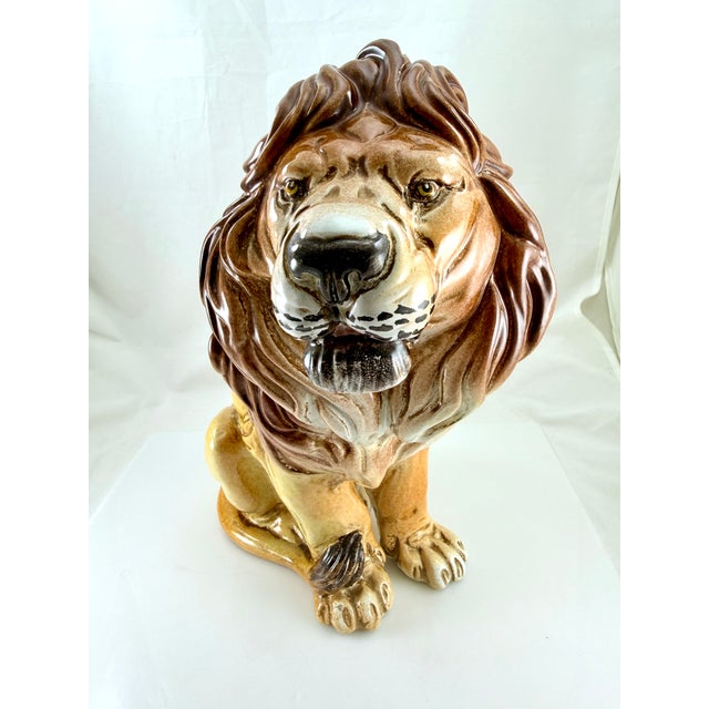 Beautiful hand painted majolica style sitting lion sculpture from the 60's crafted in Italy. Wonderful detail highlighted...