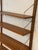 Elegant vintage Danish mid-century modern wall-mounted shelving system designed by renowned Danish designer Poul Cadovius...