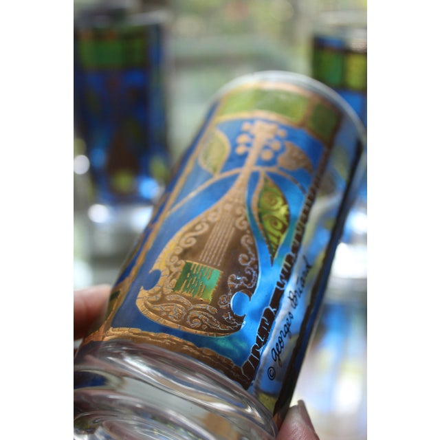 Rare and beautiful set of 4 mid-century vintage Highball glasses designed by Georges Briard. These are adorned with...