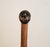 A pair of antique eight pound wooden juggling pins with bulbous bodies, fine turned ridges, a decorative black band and...
