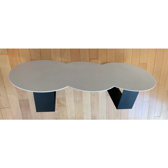 Vintage mid century modern coffee table. The biomorphic shaped top is secured to a heavy iron base.