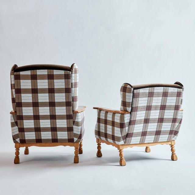 These vintage club chairs have been reupholstered in chocolate brown kid mohair with jacquard fabric accents on the sides...