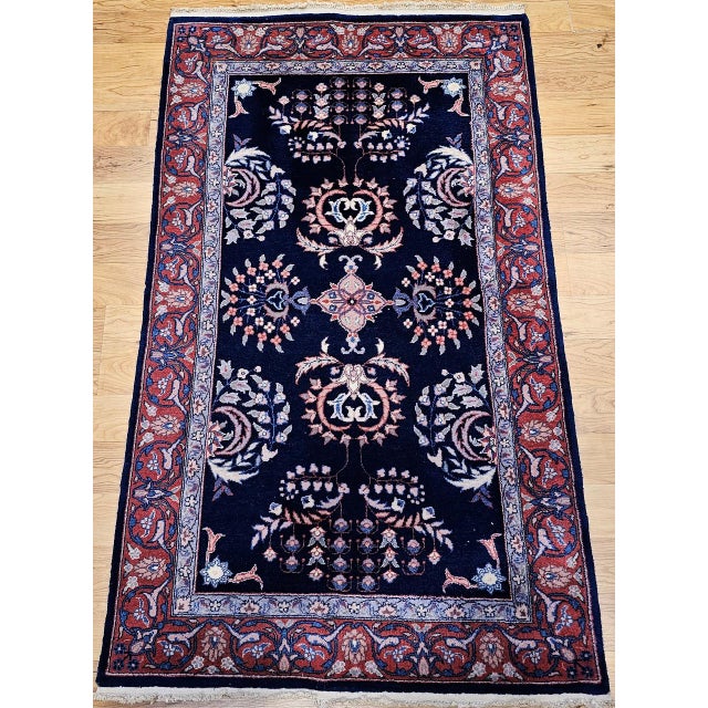 "This vintage Persian Sarouk area rug from the third quarter of the 20th century presents the refined allover floral...