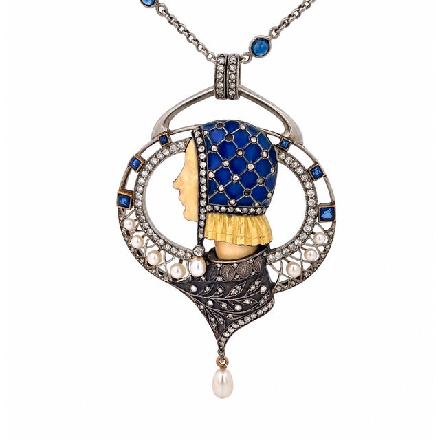 An exquisite Art Nouveau pendant is by Masriera out of Spain and it is centered on a finely carved ivory profile of a...