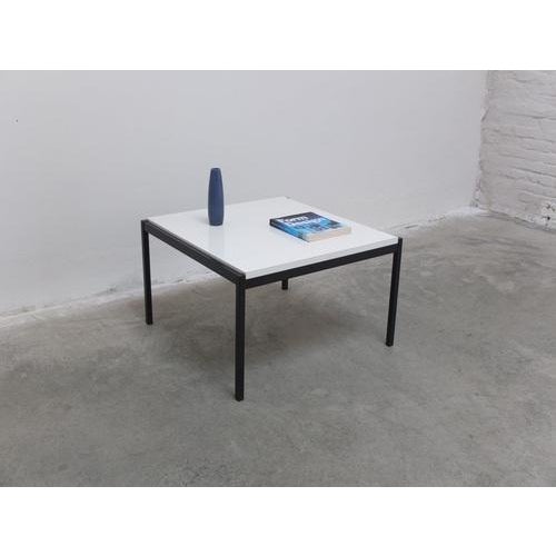 Minimalistic coffee or side table with a black lacquered metal frame and a white formica top. In very good condition with...