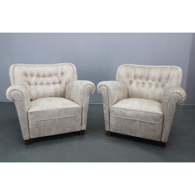 This elegant pair of Art Deco club armchairs was produced in Czechoslovakia during the 1940s and reflects the refined...