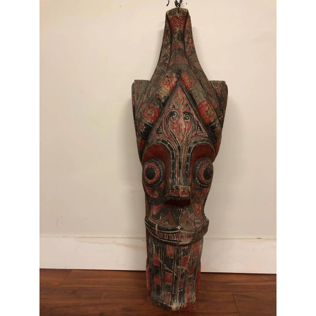 Antique Indonesian large temple head carved out of wood. This sculpture appears to be carved from a single piece of wood...