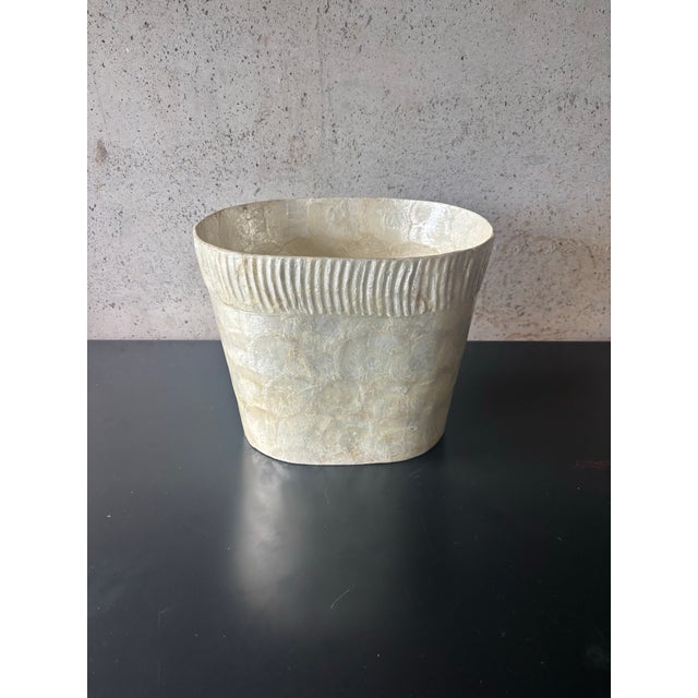 Vintage coastal wastebasket dating to the 1980s, handcrafted from natural capiz shell. Features a softly rounded...