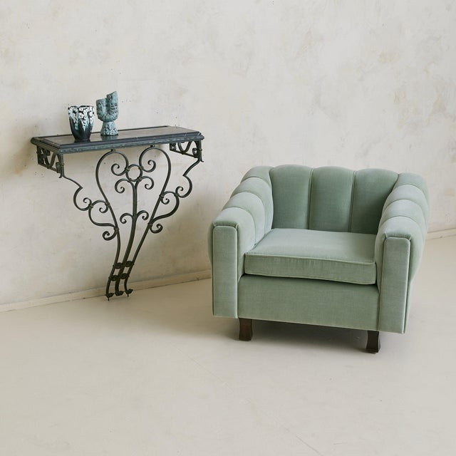 A 1940s verdigris bronze console sourced in the South of France, topped with a honed black marble slab threaded with rich...