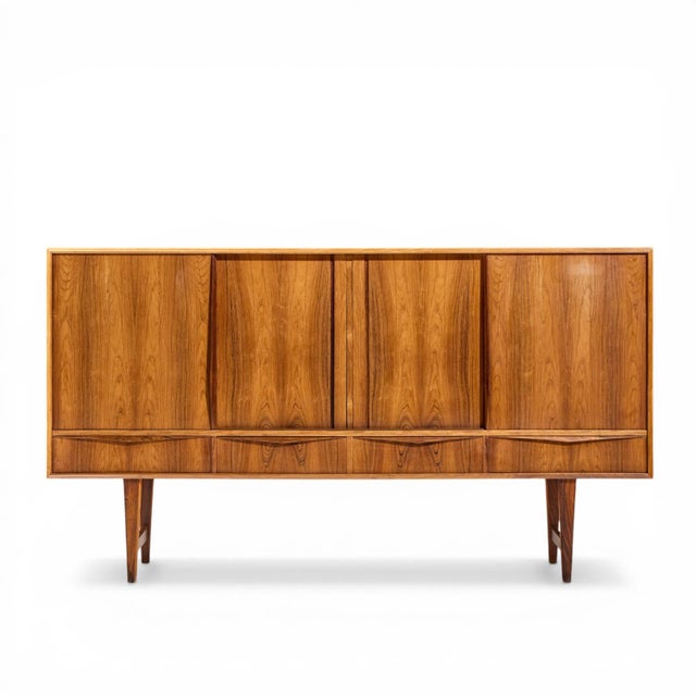 E.W. Bach for Sejling Mid Century Danish Rosewood Credenza This credenza measures: 77.25 wide x 17.25 deep x 42.75 inches...