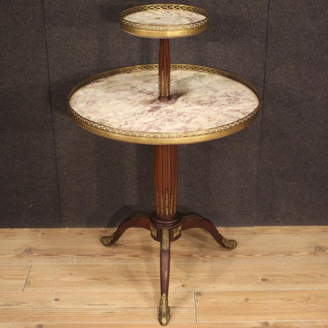 French étagère furniture from the early 20th century. Side table carved in mahogany wood richly adorned with gilded and...