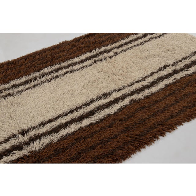 Hand-knotted in high-pile wool in Sweden circa 1960-1970, this 5x7 vintage Swedish Rya rug is a bold new addition to Rug &...