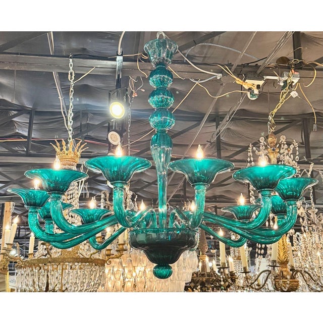 The Modern Murano Teal Glass Chandelier is a stunning and stylish lighting fixture that adds a touch of elegance to any...