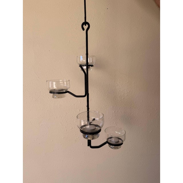 Vintage Scandinavian-style wrought iron hanging candelabra in the manner of Erik Höglund. A sculptural piece featuring a...