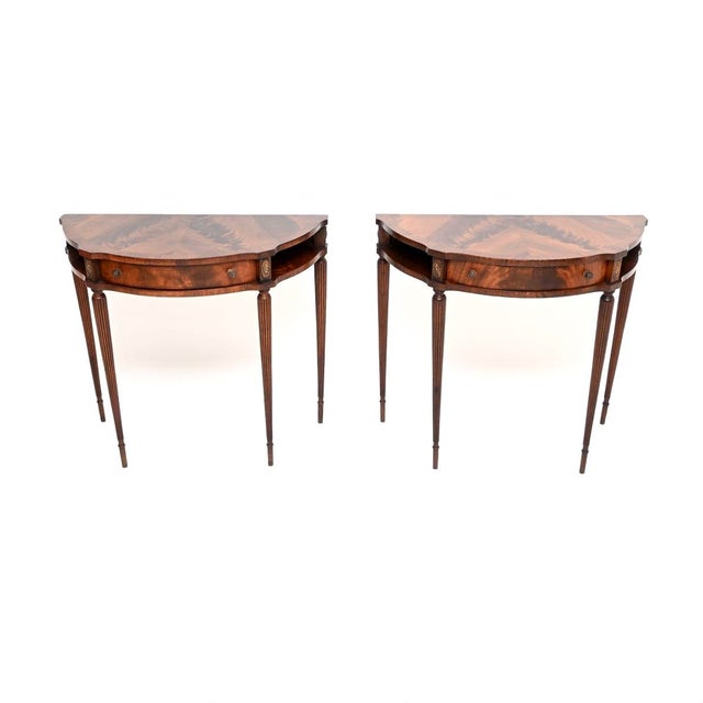 A beautiful and elegant pair of antique Regency style console tables. They were made in England, and date from around the...
