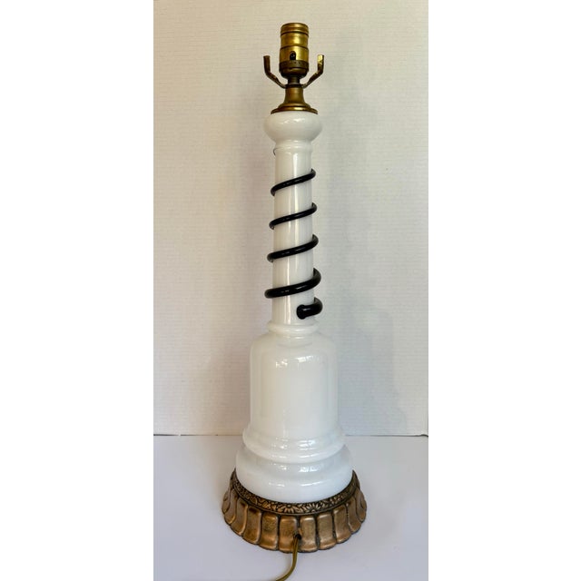 This distinctive vintage table lamp features a sculptural milk glass body wrapped with a dramatic deep cobalt blue spiral...