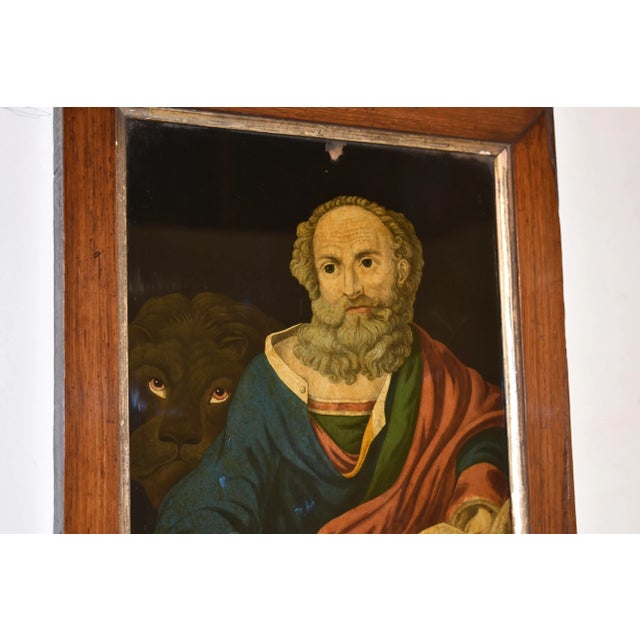Pair of extraordinary reverse paintings on glass of St. Mark and St. John. St. Mark has a lion behind him and St. John has...