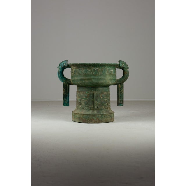 This Archaic Bronze Gui Vessel with Taotie Beast is a striking and versatile item due to its proportions and patination....