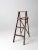 Here is vintage wooden a-frame folding ladder. The brown wood painter's ladder features splattering and drips of multiple...