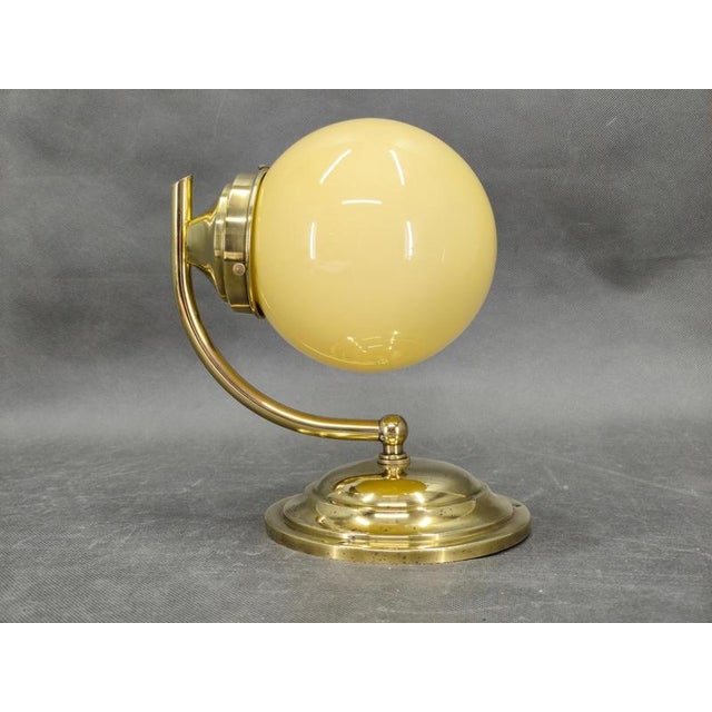 Rare art deco wall light produced in czechoslovakia during the 1930s. This elegant modernist fixture features a gracefully...