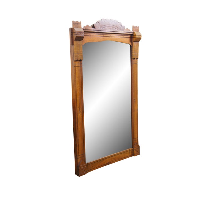 This antique Eastlake movement pier mirror features a stately, architectural solid walnut frame highlighted by a carved...