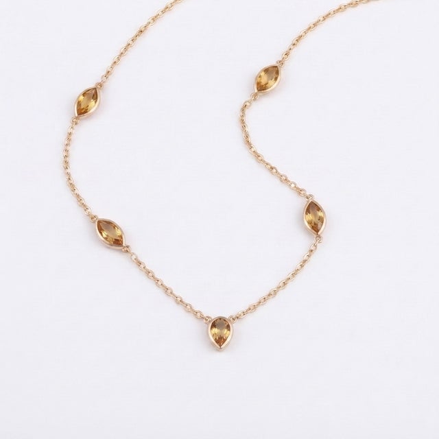 Bring warmth and elegance to your collection with this stunning station necklace. Designed for the modern minimalist, this...