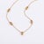 Bring warmth and elegance to your collection with this stunning station necklace. Designed for the modern minimalist, this...
