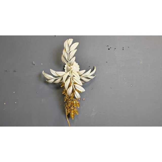 Vintage white metal and brass wall lamp by Hans Kögl. Cool decorative floral wall light with an E14 light bulb. Tested and...