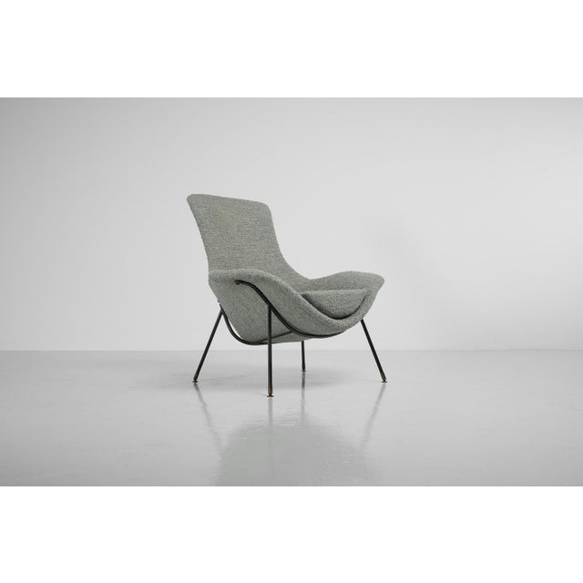 Striking 'Cosmos' lounge chair designed by Augusto Bozzi and manufactured by Saporiti, Italy 1954. This beautiful shaped...